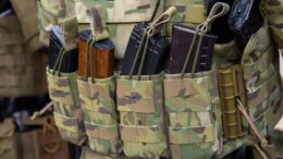 a molly bag with molle pouches attached to it containing ammo