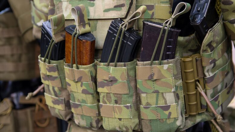 a molly bag with molle pouches attached to it containing ammo